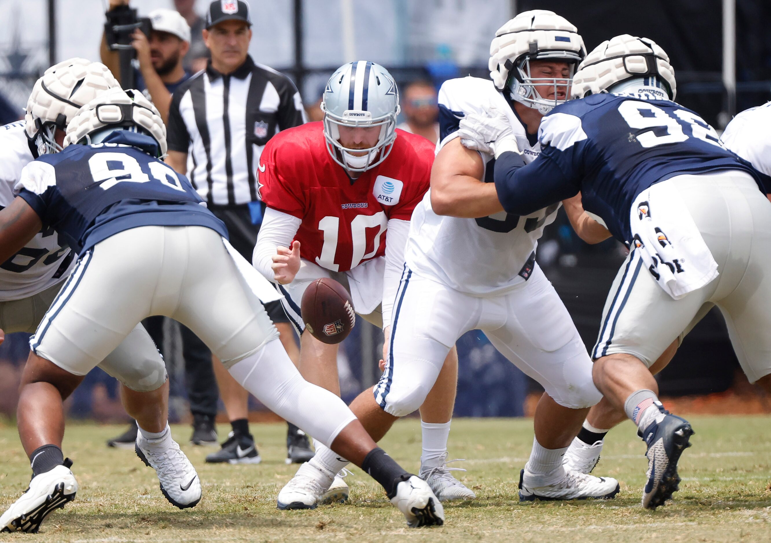 Dallas Cowboys quarterback Cooper Rush (10) drops a snap from center Tyler Biadasz (63)...