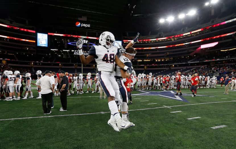 Allen's Courtenay Moore (48) and Ryan Angeloni (13) celebrate a 28-14 win over South Grand...