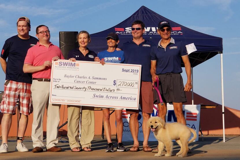 Swim Across America Dallas representatives present a $270,000 check to Baylor Charles A....