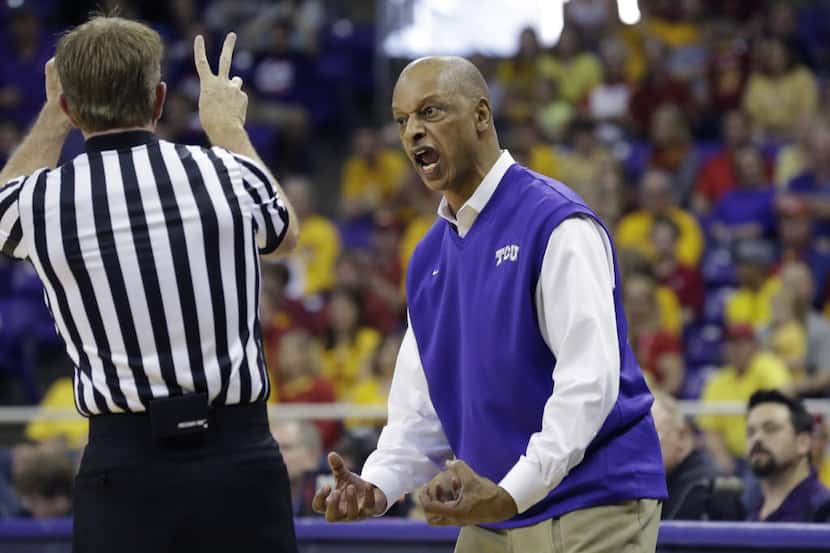 TCU head coach Trent Johnson, right, protests a call by the referee during the first half of...
