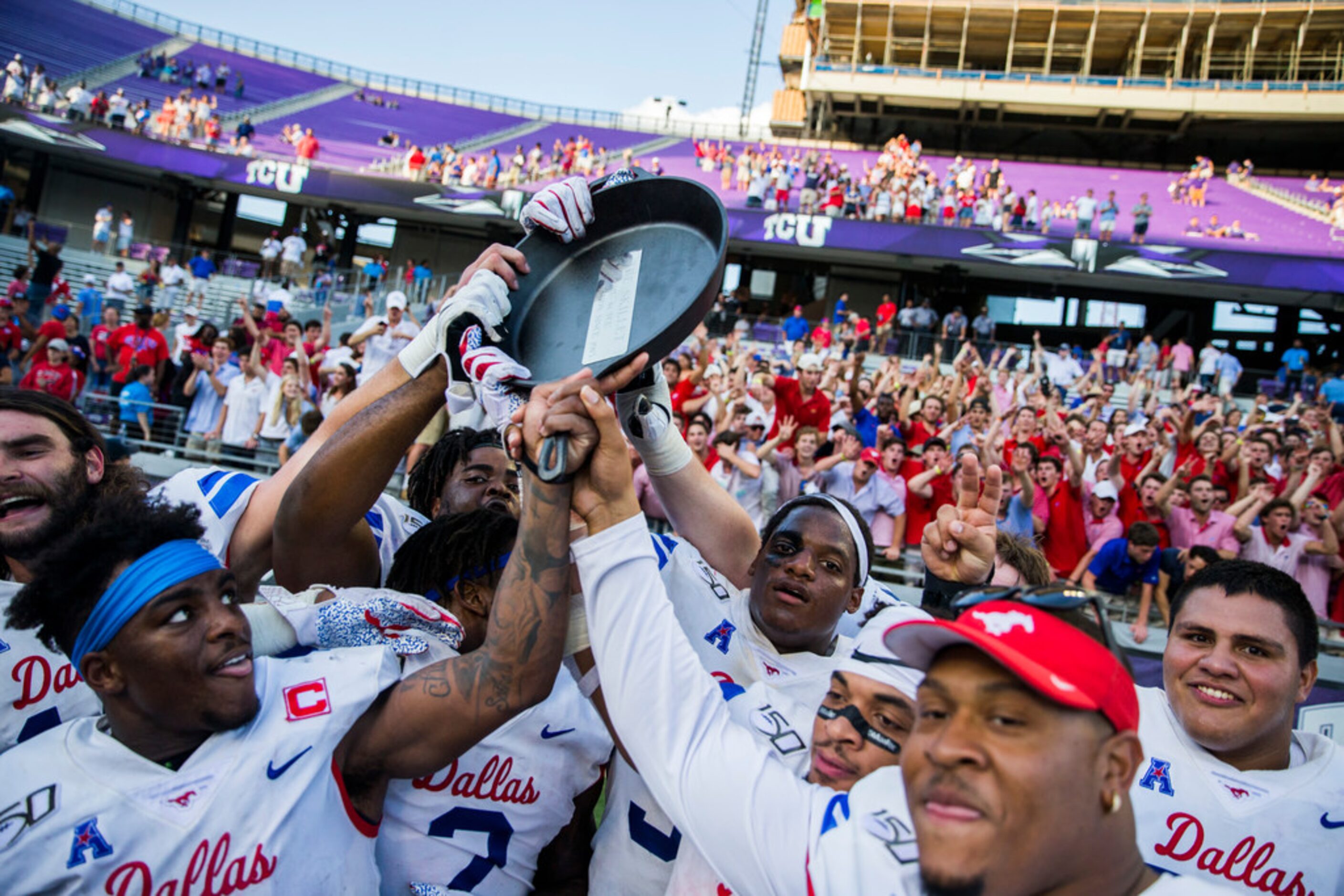 Southern Methodist Mustangs celebrate a 41-38 win over TCU Horned Frogs by hoisting the...