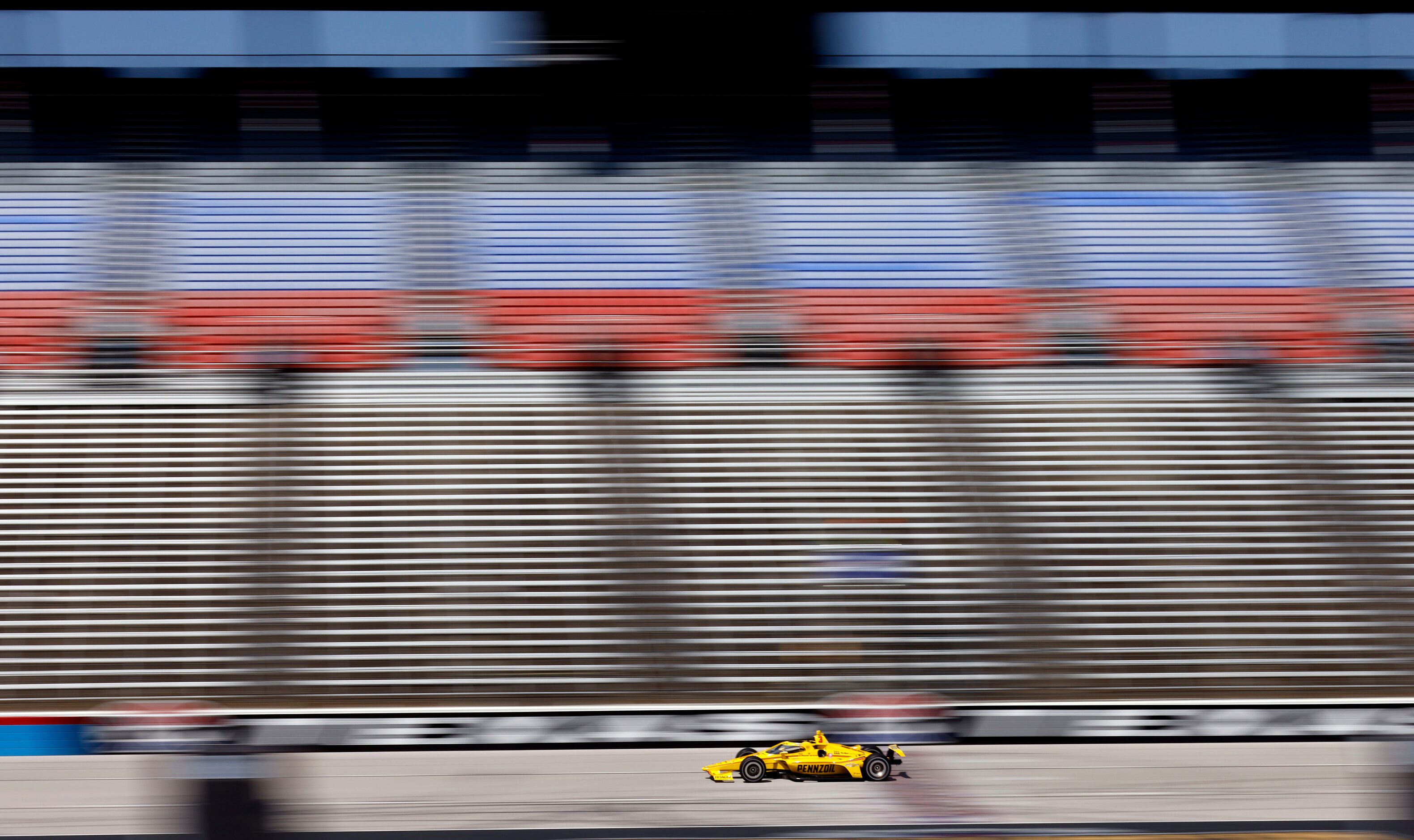 Indy Car driver Scott McLaughlin speeds down the front stretch as he practices for the...