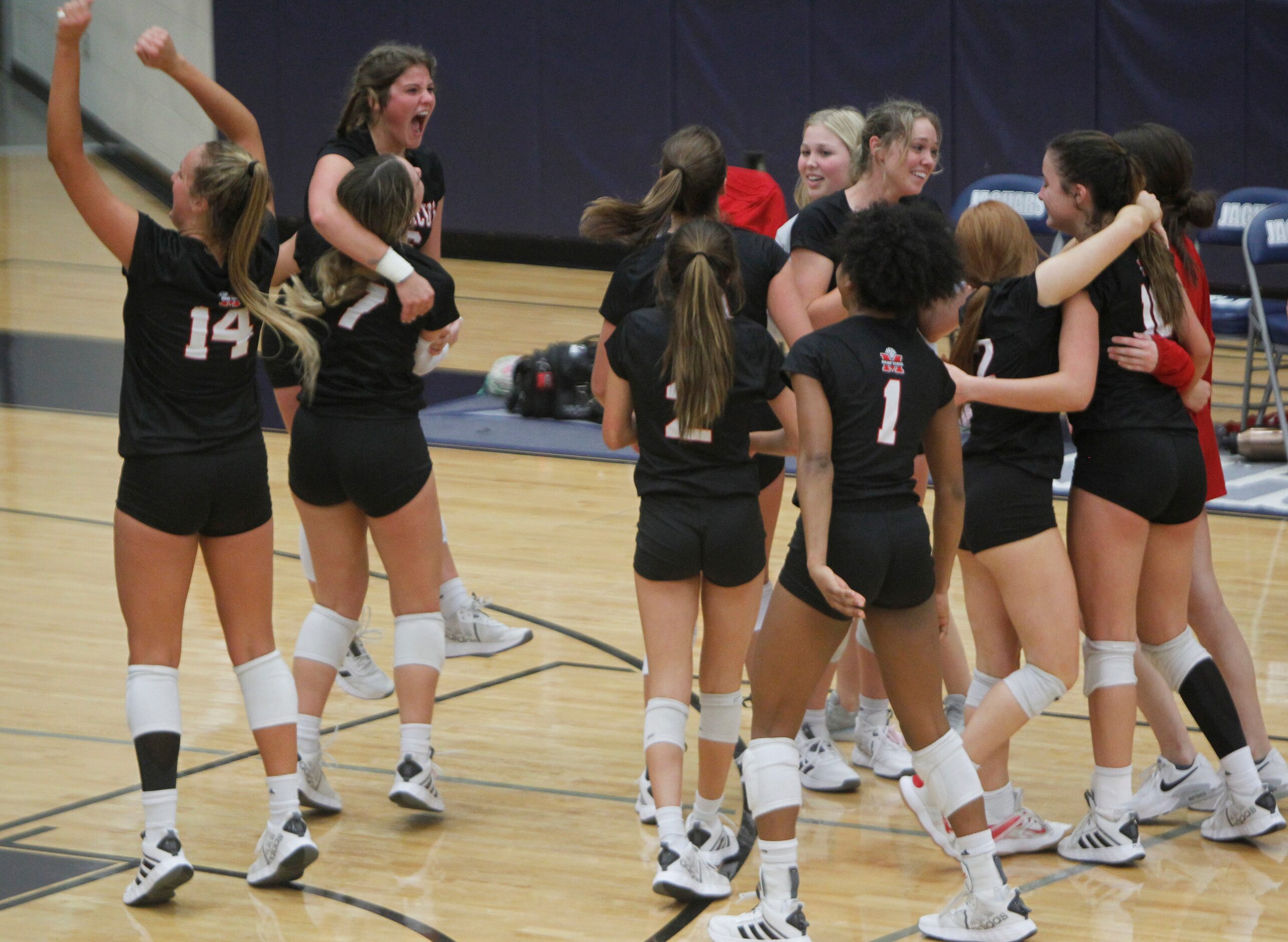 Members of the Flower Mound Marcus Marauders celebrate their 5-set victory over Flower...