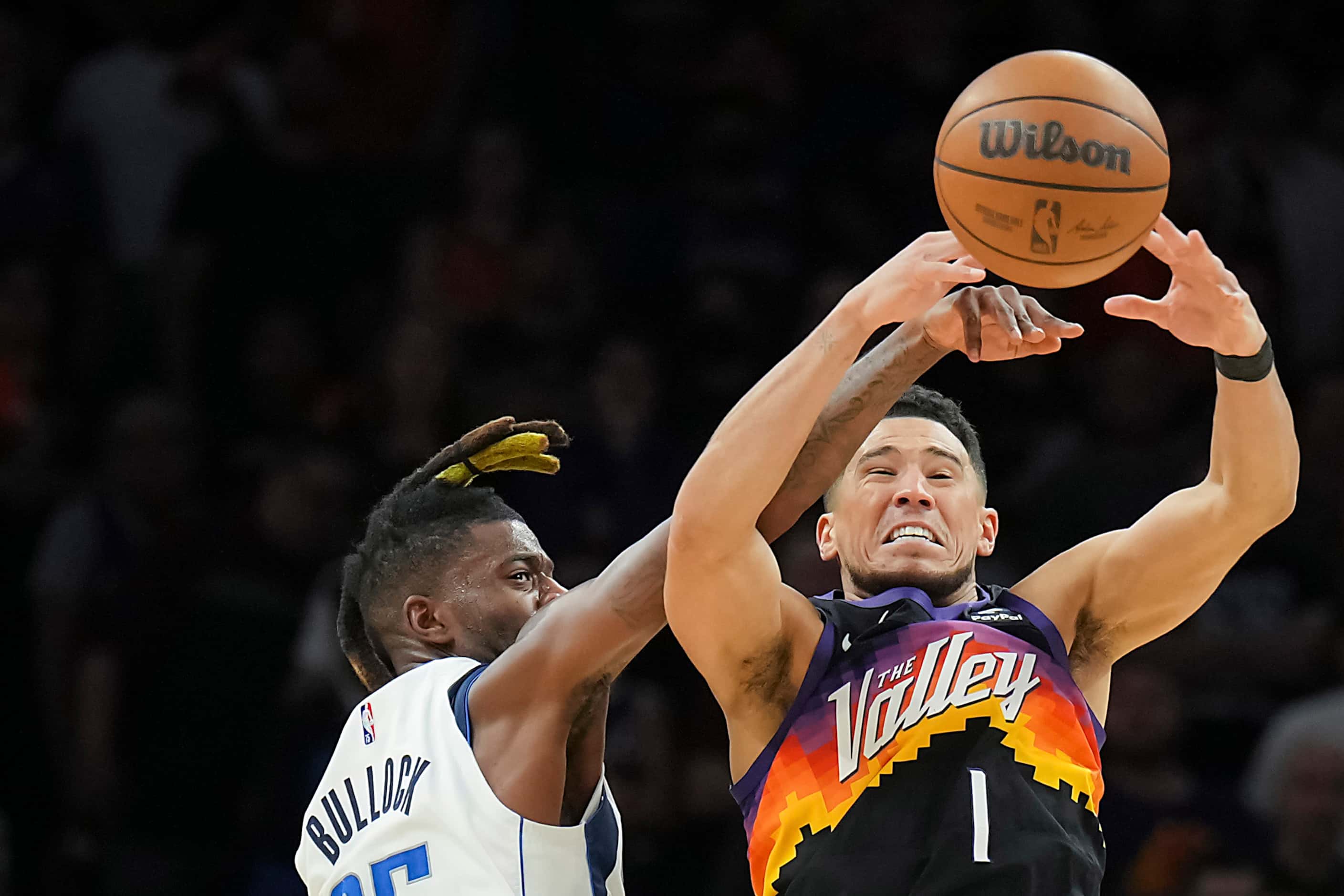 Dallas Mavericks forward Reggie Bullock (25) knocks the ball away from Phoenix Suns guard...