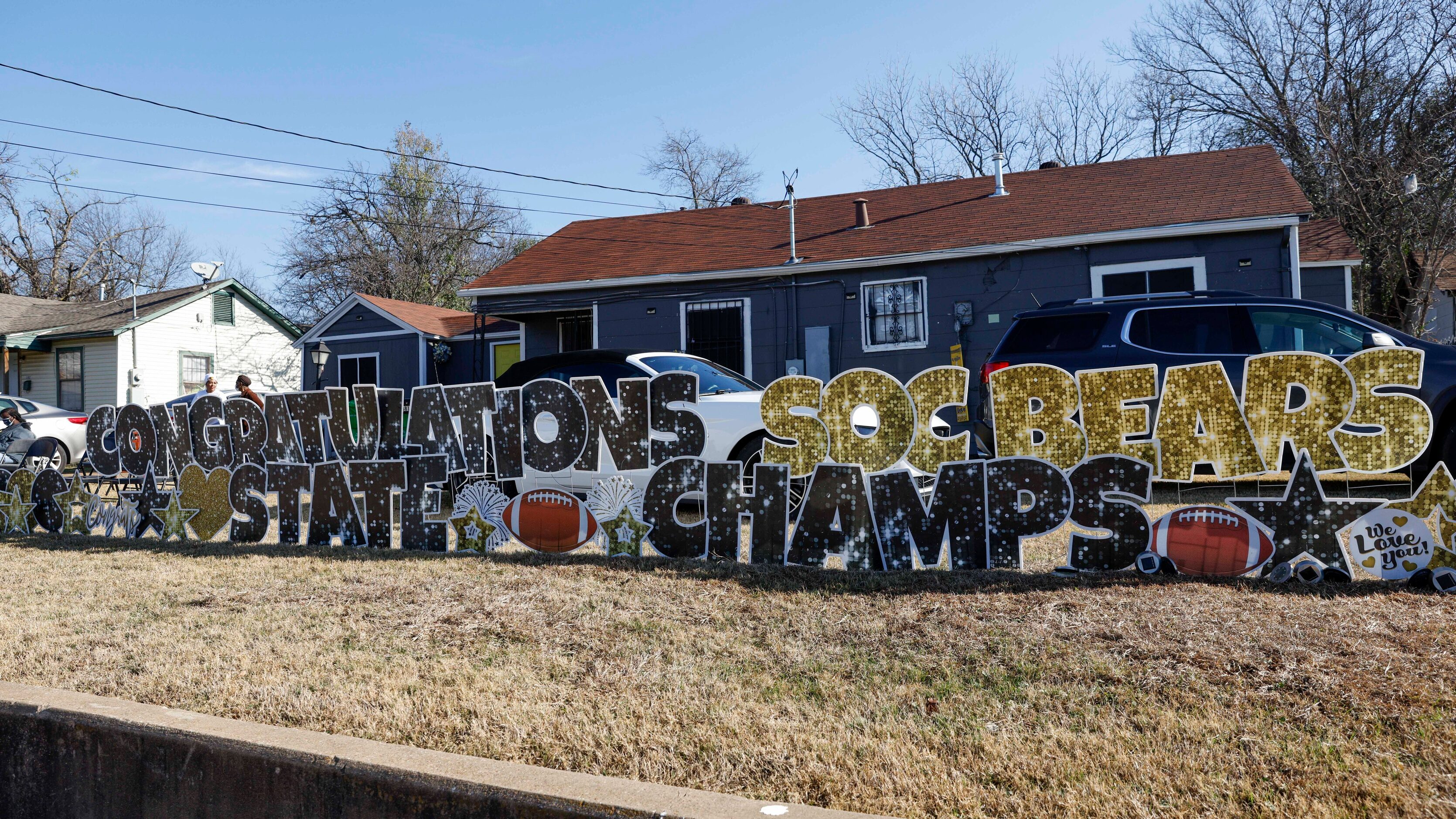 A yard sign along Marsalis Avenue congratulates the South Oak Cliff team during a parade...