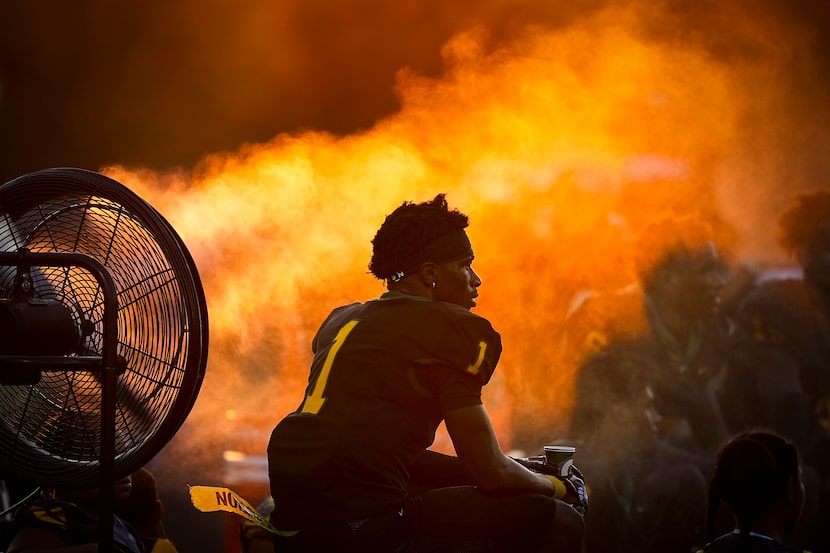 DeSoto wide receiver Johntay Cook II cools off on the sidelines during the first half of a...