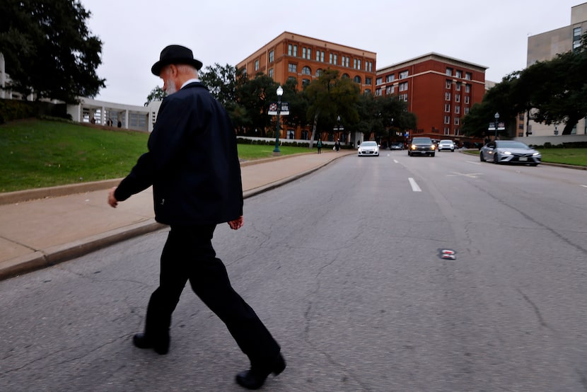 Tour bus driver Duane Kirchner of Branson, Mo., crosses Elm St in Dealey Plaza on Nov. 16,...