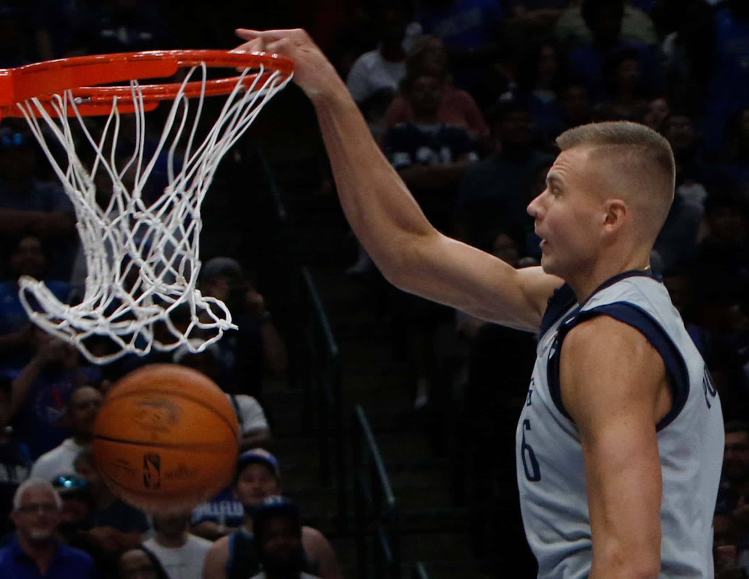 Dallas Mavericks center Kristaps Porzingis (6) makes the net dance as he dunks during...