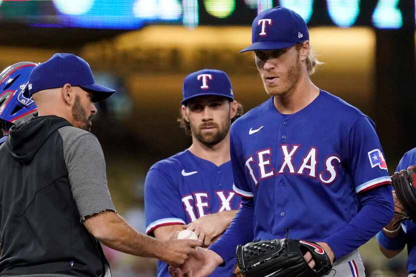 Texas Rangers starting pitcher Mike Foltynewicz, right, is taken out of the game by manager...