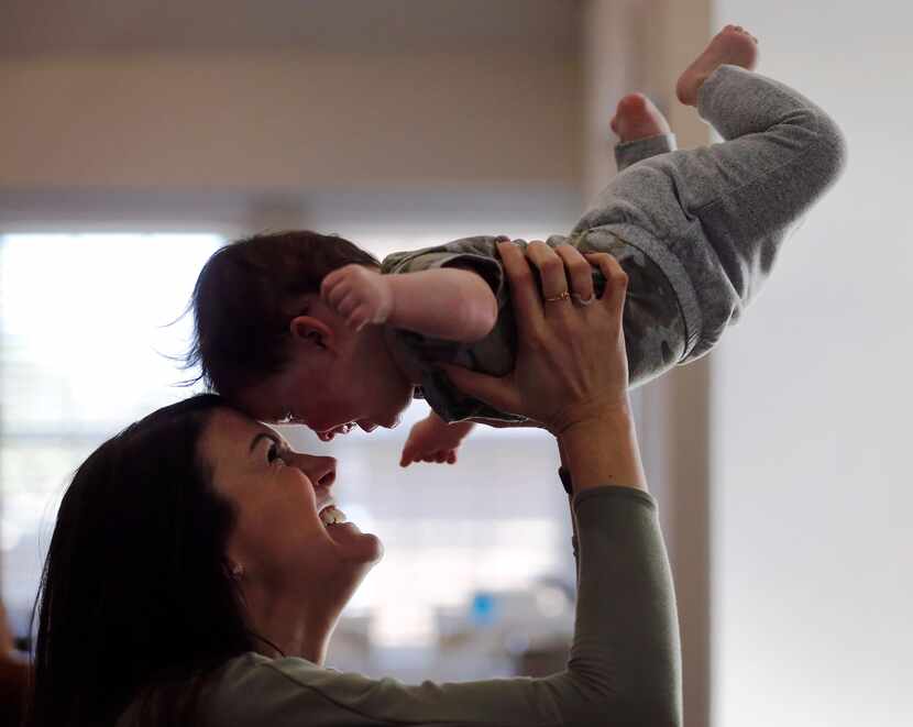 Jenny Marr plays with her son Hudson Marr (10 months) after he bumped into his brother at...