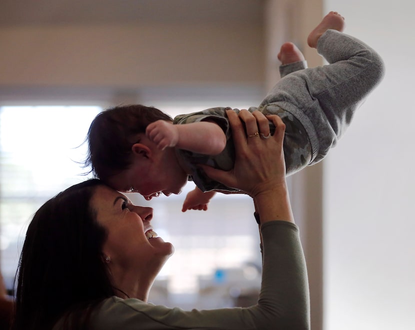 Jenny Marr plays with her son Hudson Marr (10 months) after he bumped into his brother at...