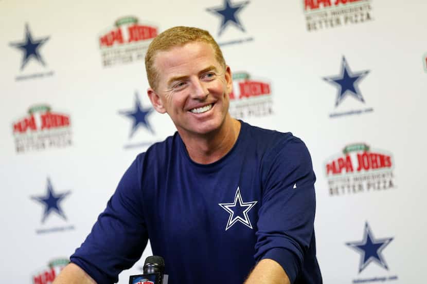 Dallas Cowboys head coach Jason Garrett shares a laugh with the media during his press...