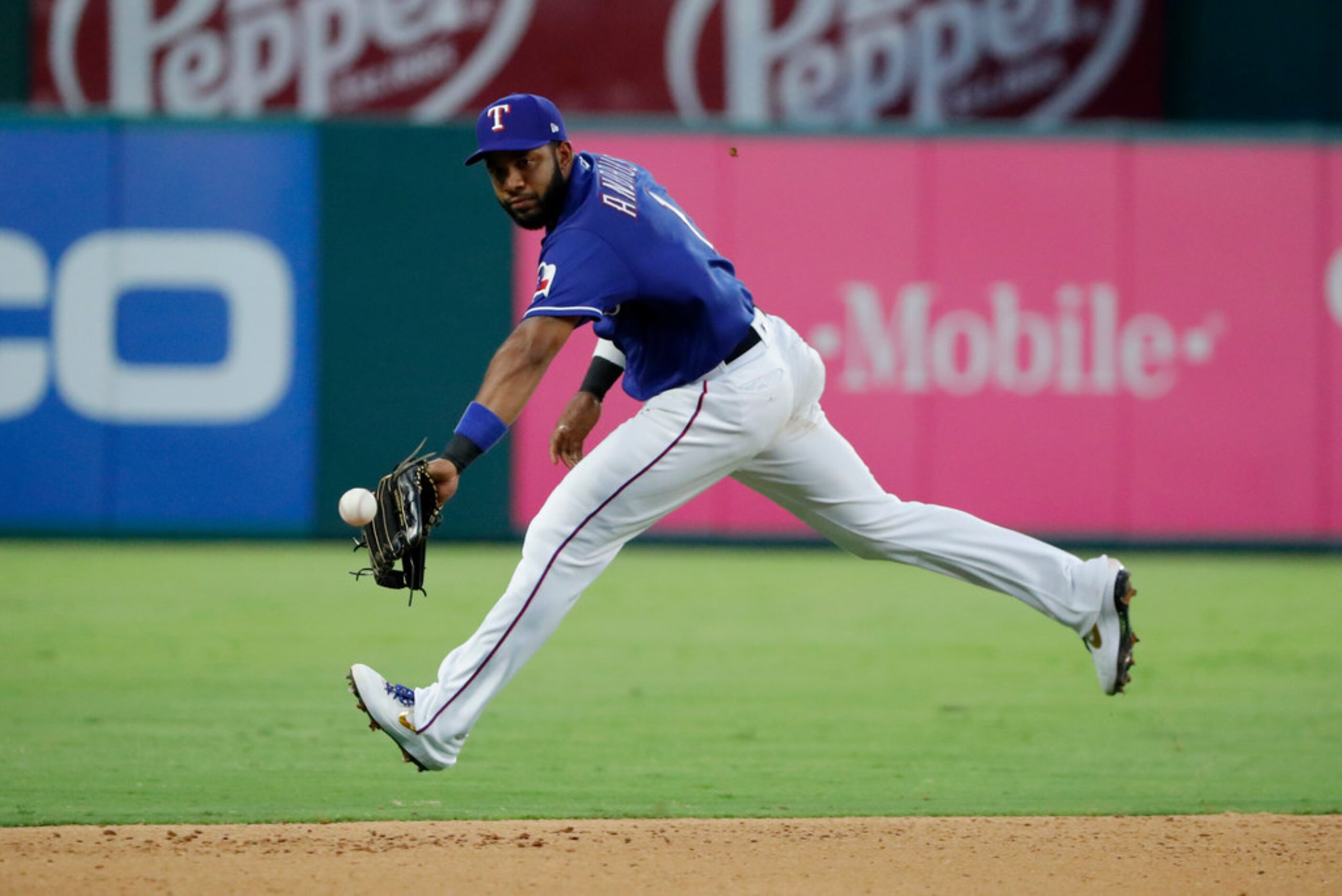 Texas Rangers shortstop Elvis Andrus is unable to reach a single by Minnesota Twins' Marwin...