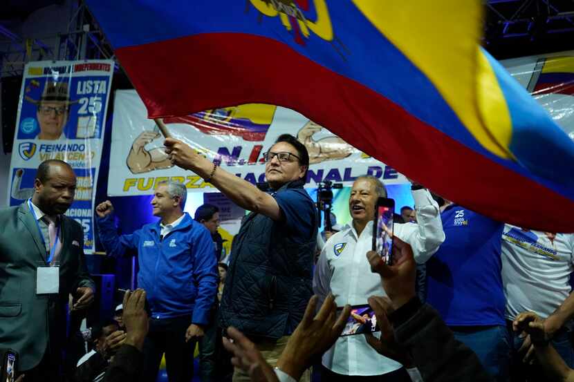 Presidential candidate Fernando Villavicencio waves an Ecuadorian flag during a campaign...