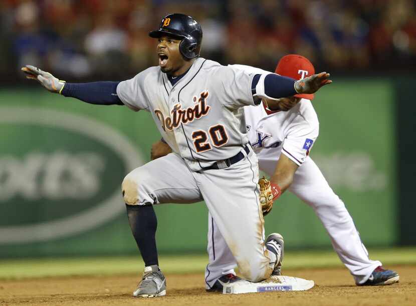 Detroit Tigers center fielder Rajai Davis (20) safely slides into second base as Texas...