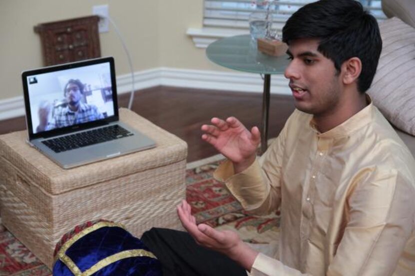 
Plano High School junior Jay Appaji reviews a mridangum lesson with his instructor,...