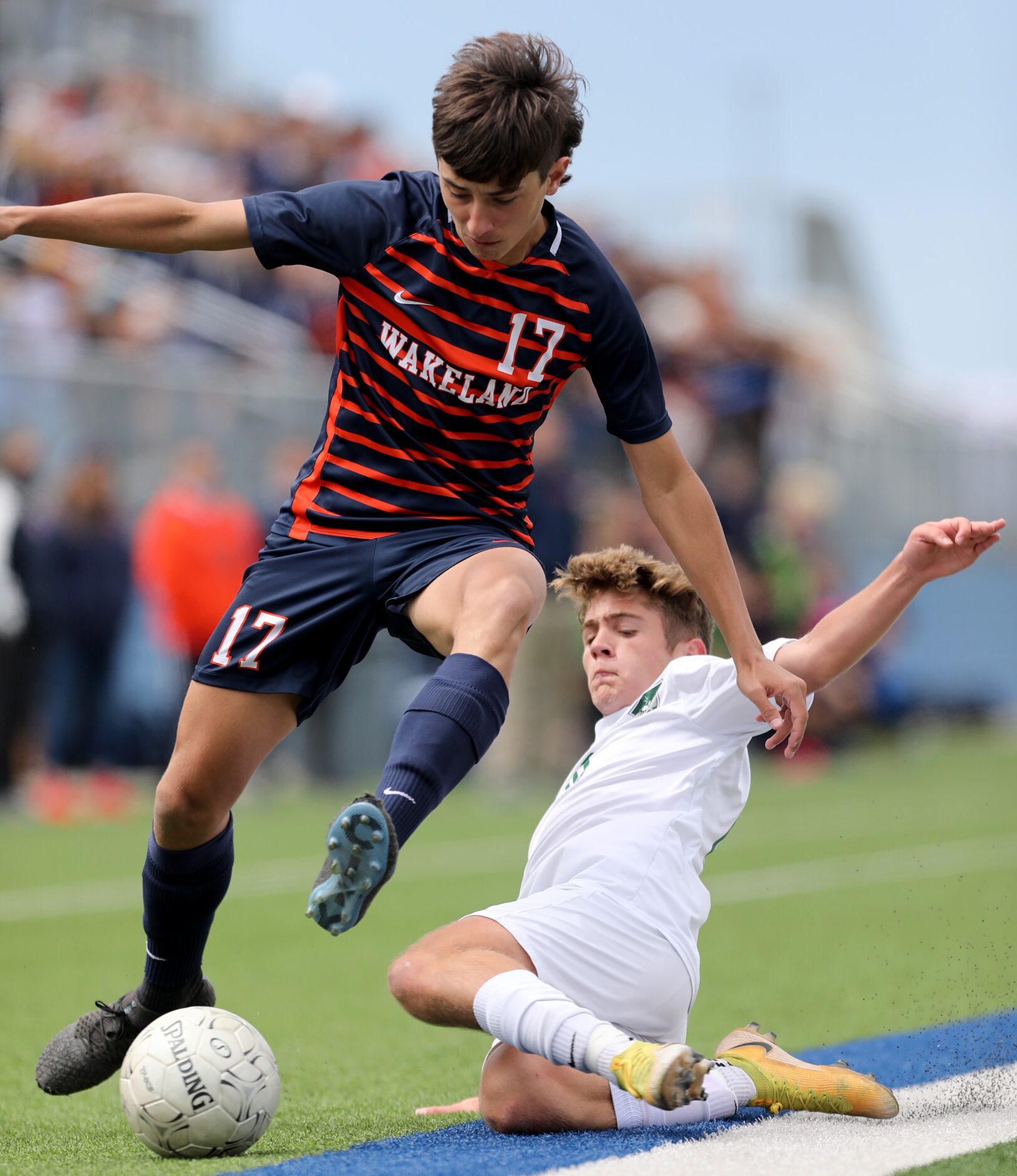 Frisco Wakeland's Riley Garza (17) and Humble Kingwood Park's Trey Ricker (10) chase after...