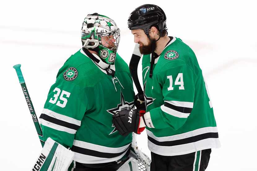 Dallas Stars left wing Jamie Benn (14) congratulates goaltender Anton Khudobin (35) on their...