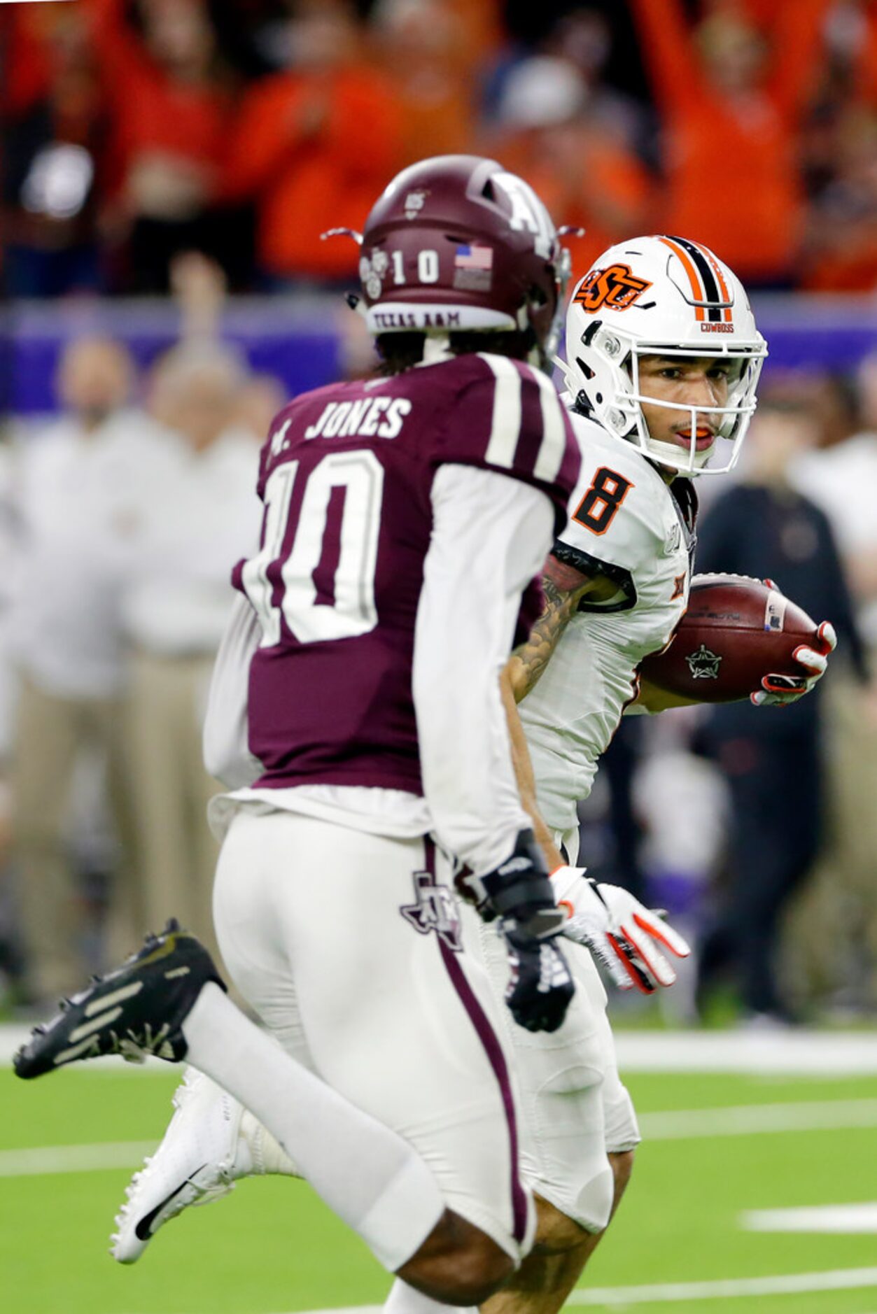 Oklahoma State wide receiver Braydon Johnson (8) looks back at Texas A&M defensive back...