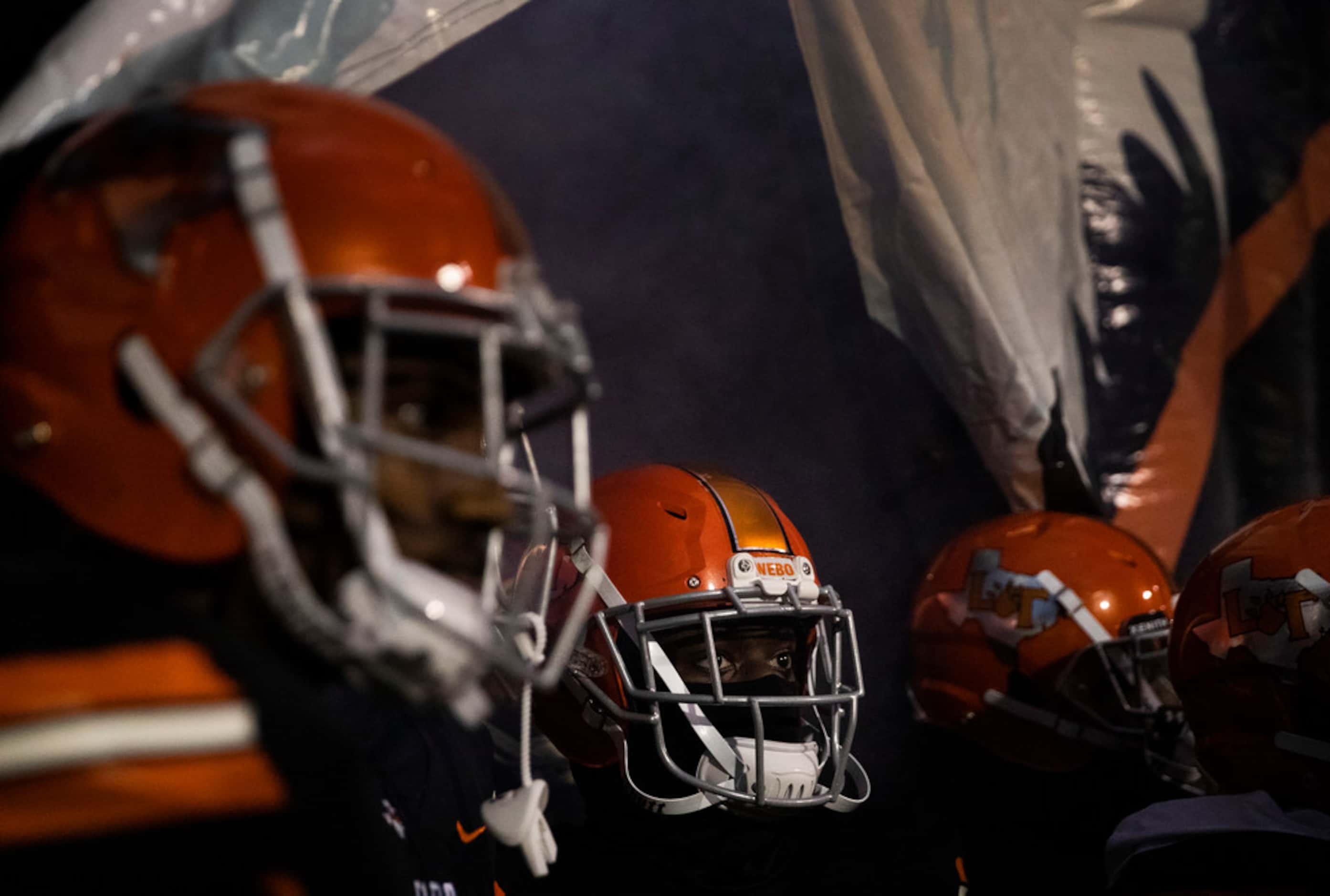 Lancaster players prepare to enter the field before a District 6-5A Division I high school...