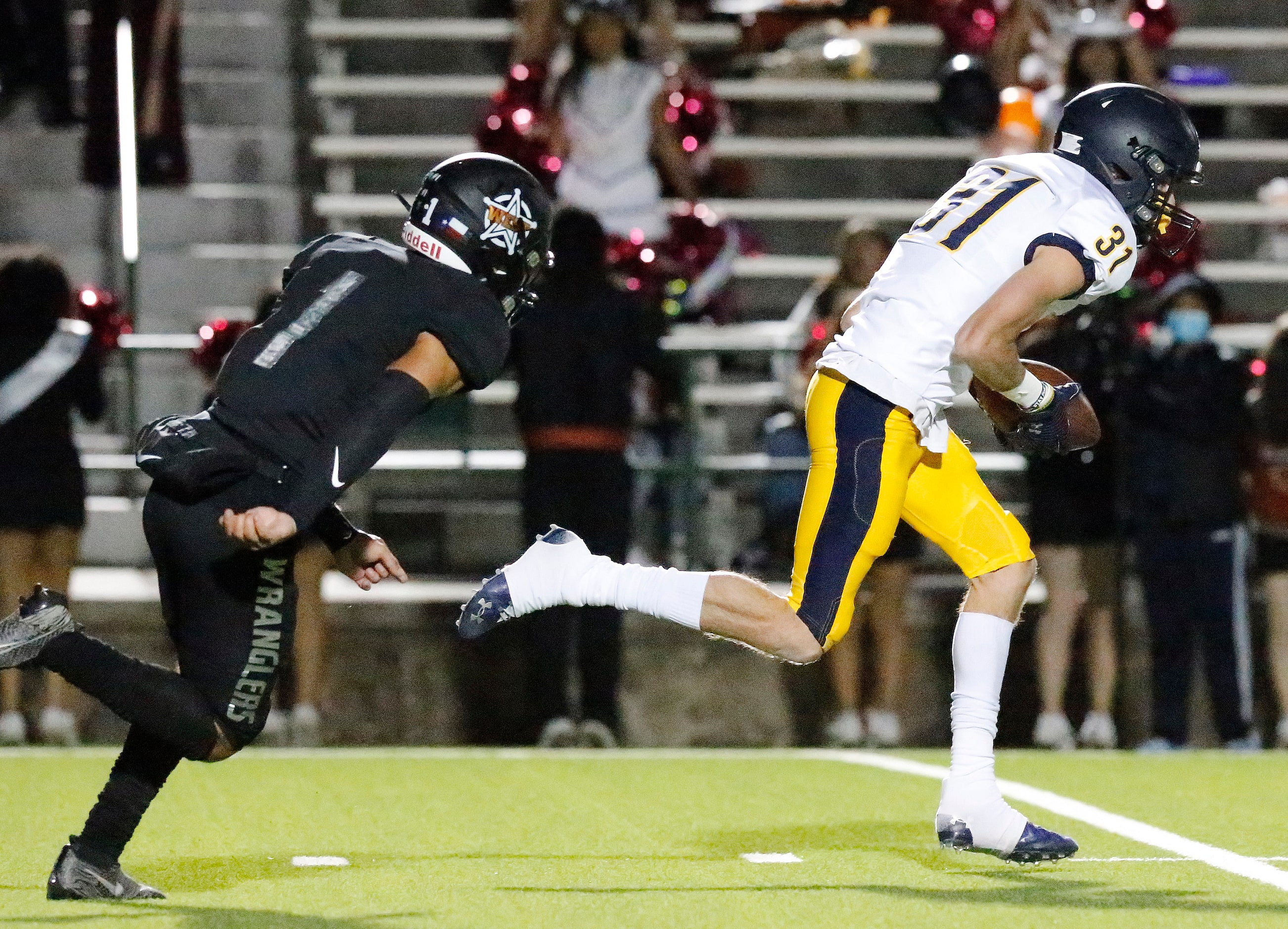 Highland Park High School defensive back Blake Bevans (31) carries a blocked extra point...