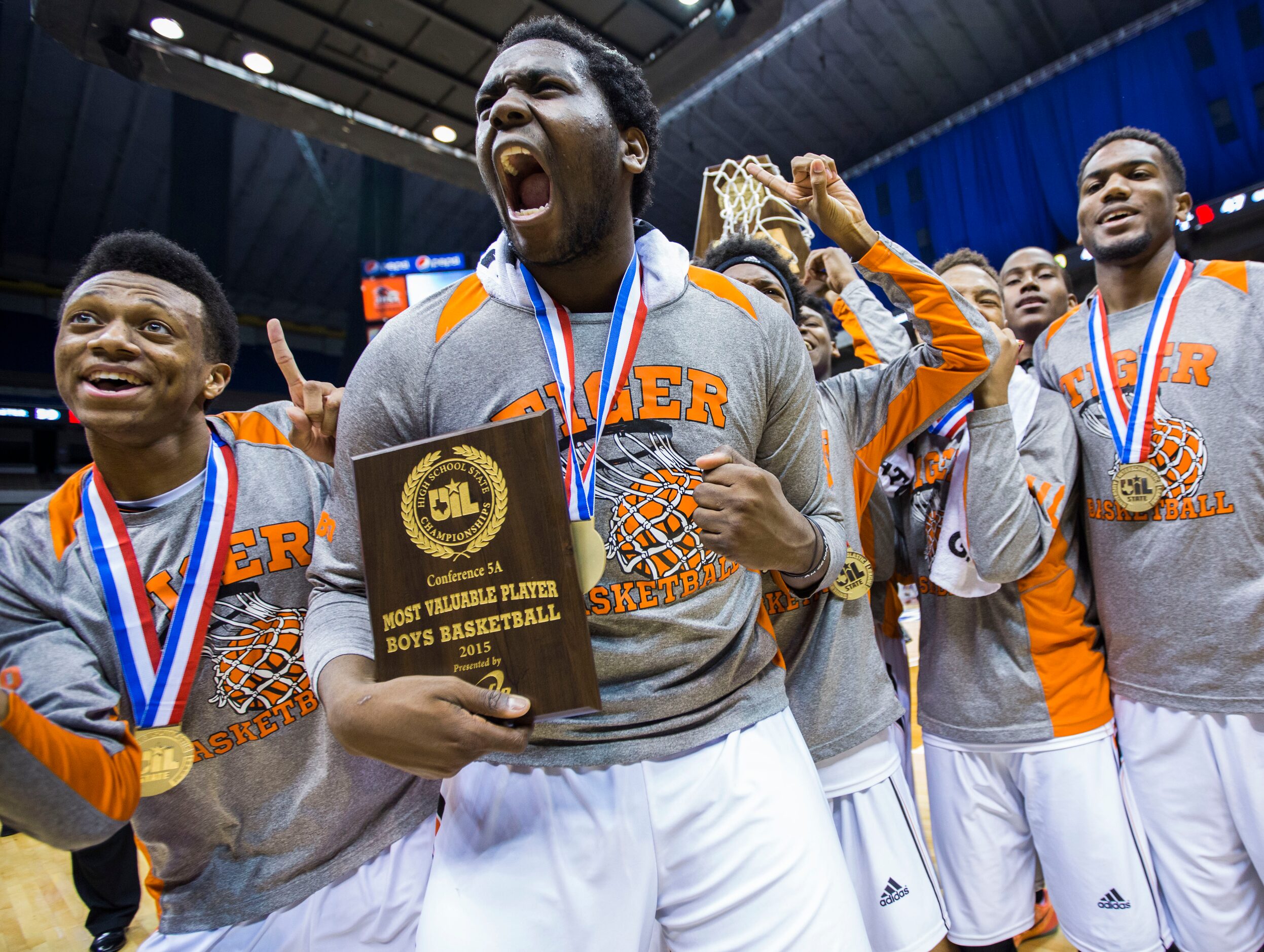 MVP Lancaster forward/center Elijah Thomas (15) and team mates celebrate a 59-47 win over...