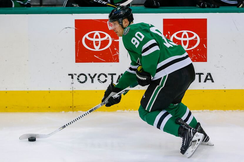 Dallas Stars center Jason Spezza (90) skates with the puck during the third period of an NHL...