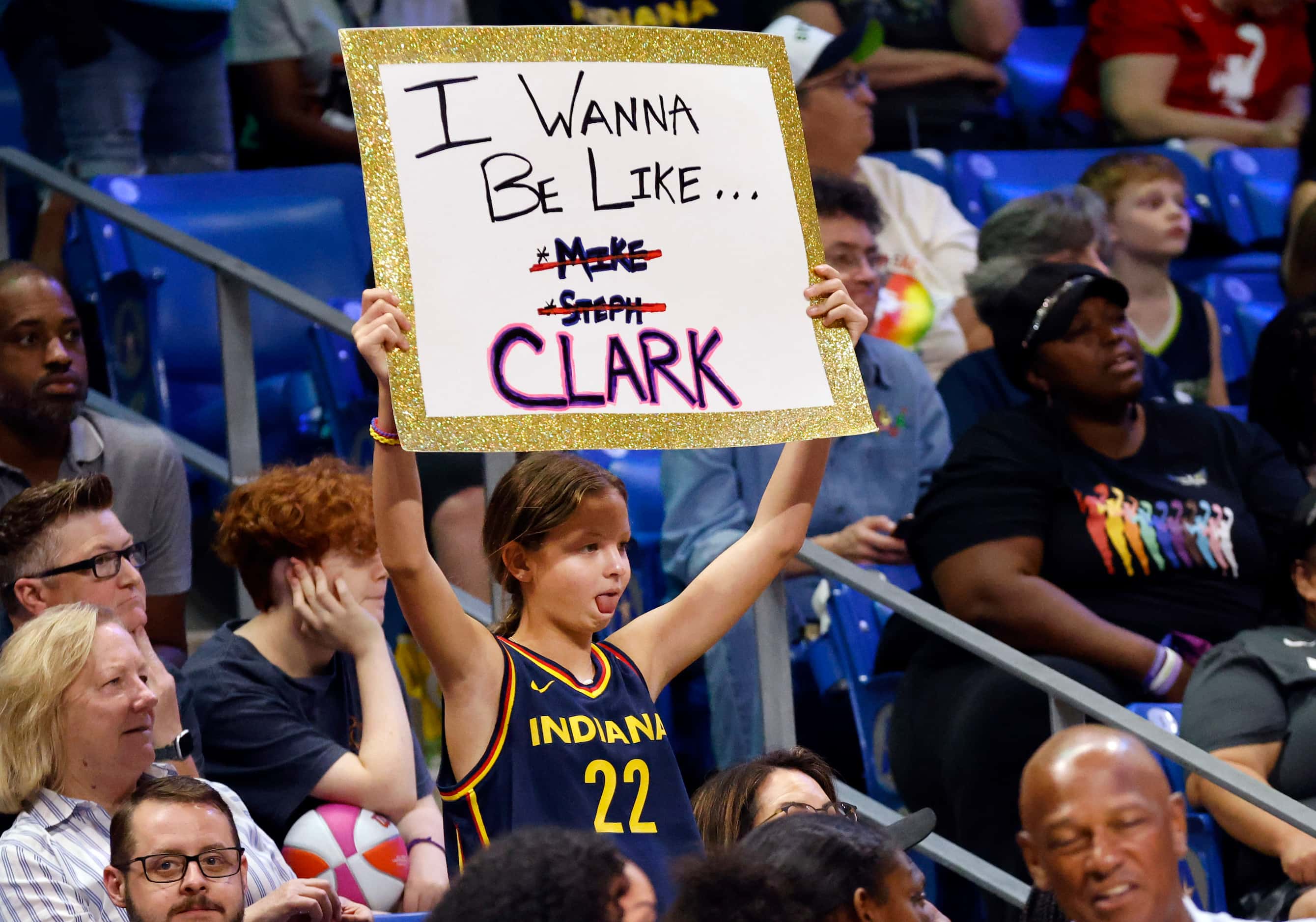 A found fan shows her support for Indiana Fever guard Caitlin Clark during their game...