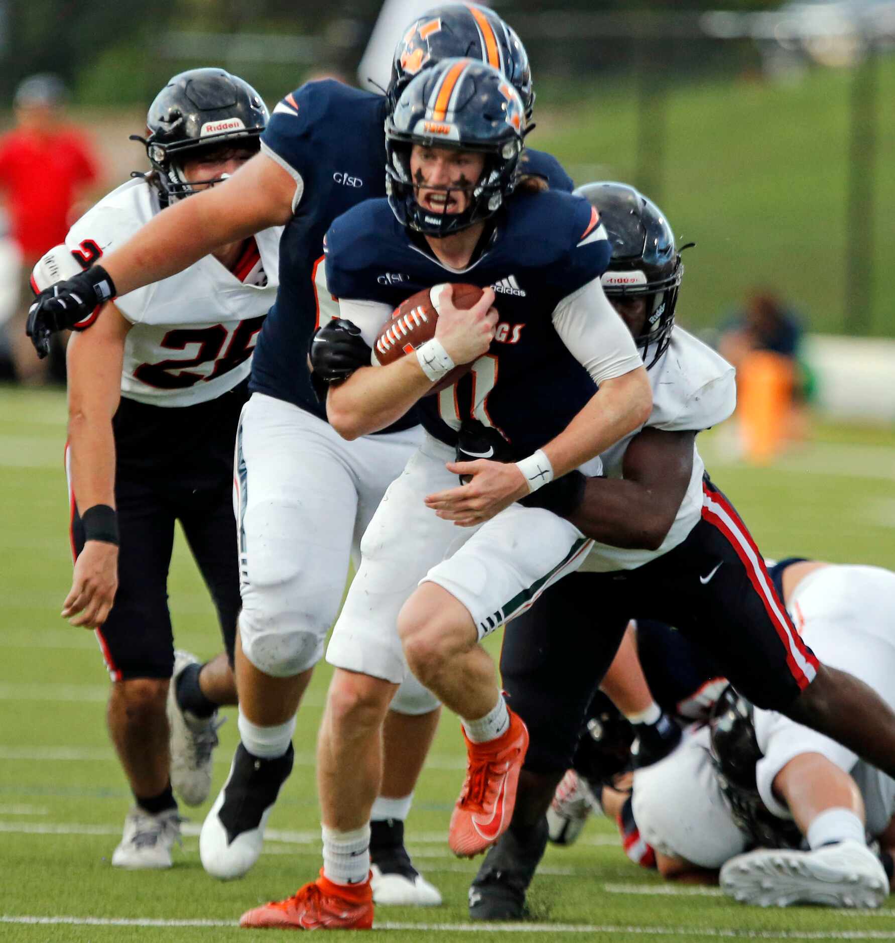 Sachse QB Grayson King (11) is tackled during the first half of a high school football game...