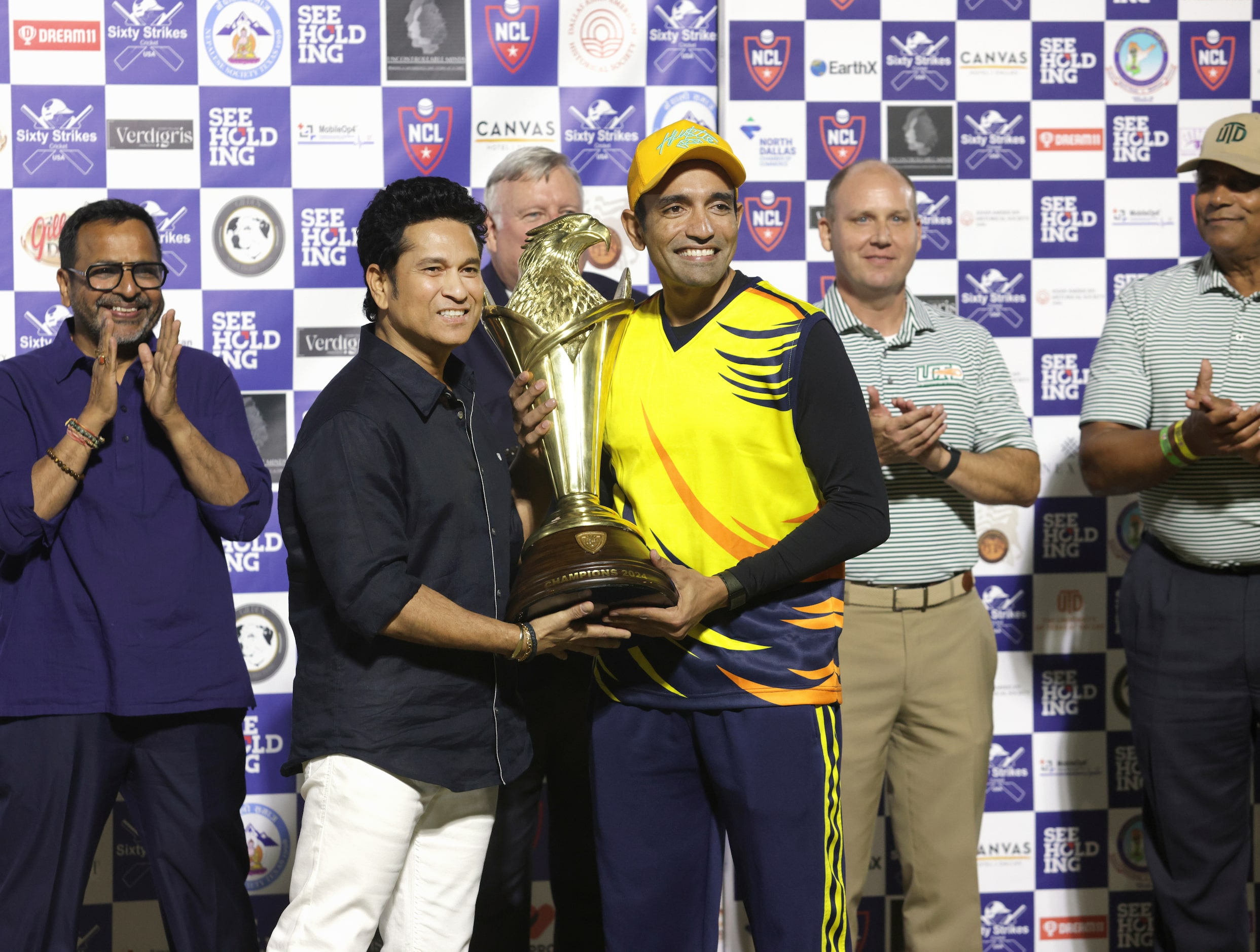 Sachin Tendulkar presents a trophy to The Chicago Cricket Club after winning the NCL cricket...