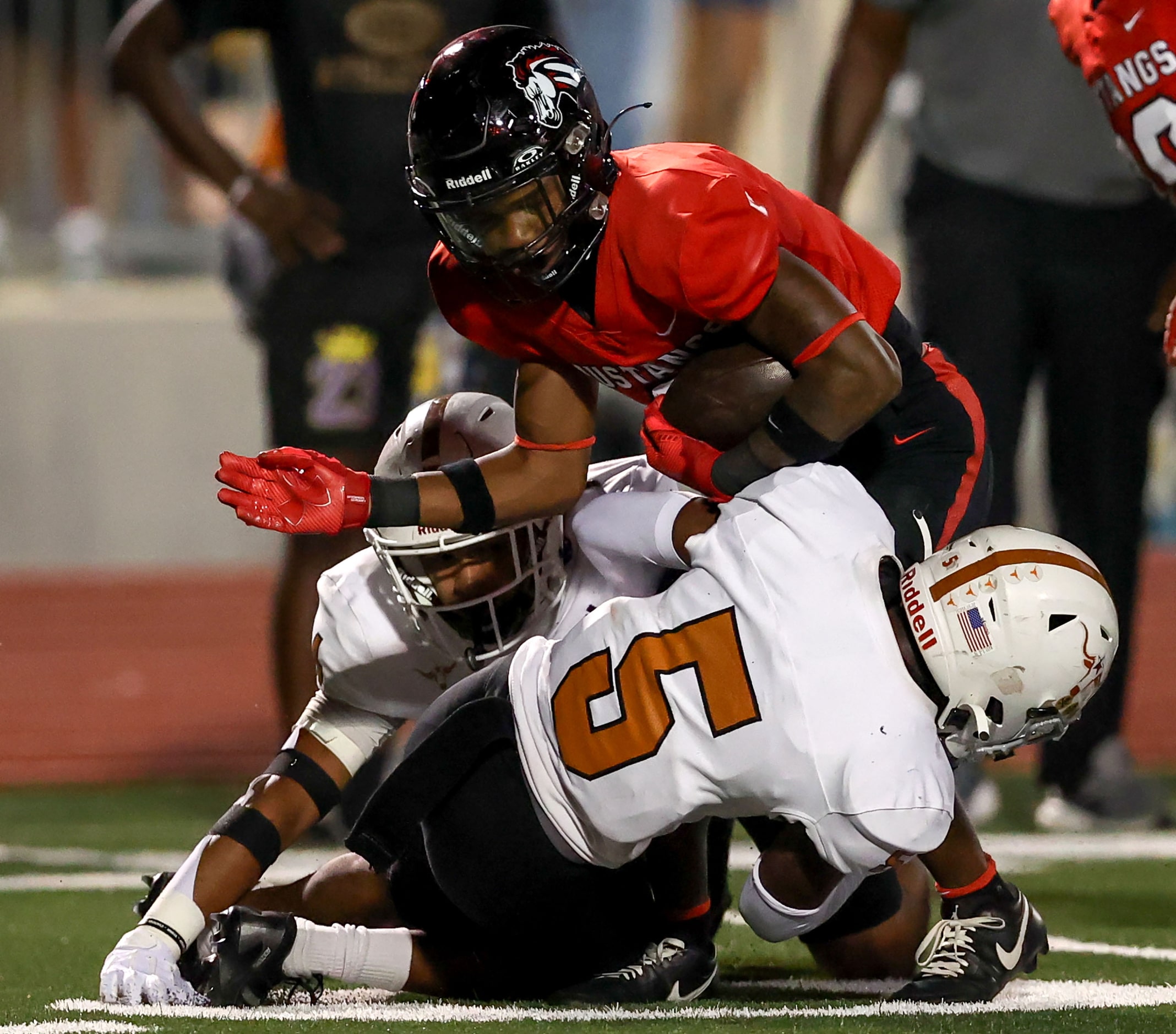 Creekview running back Jnoah Drumgole is stopped for a short gain by W.T. White defensive...