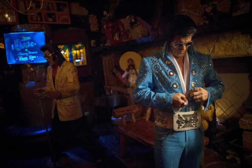 John Ehrenberger puts the final touches on his jumpsuit as he prepares to perform as Elvis...