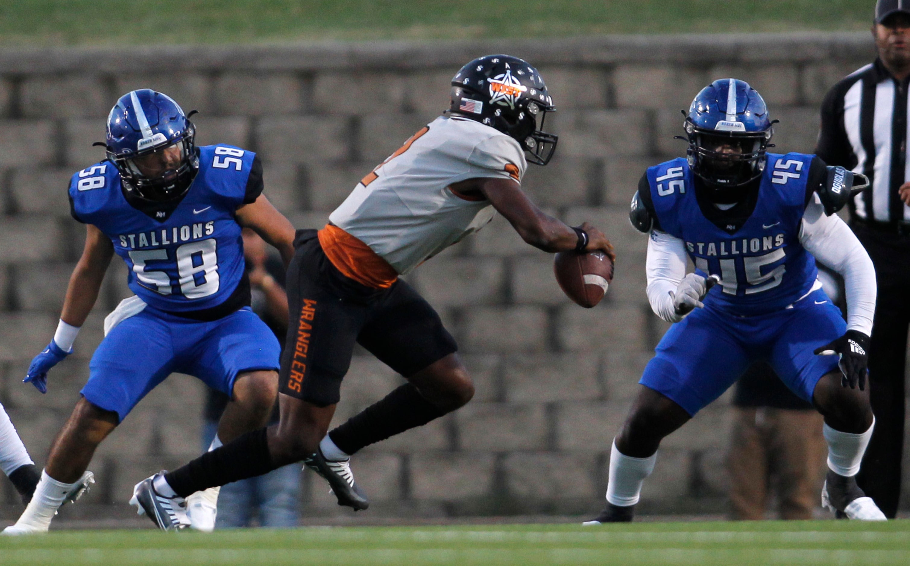 West Mesquite quarterback Craig Dale (2), center, attempts to avoid North Mesquite defensive...