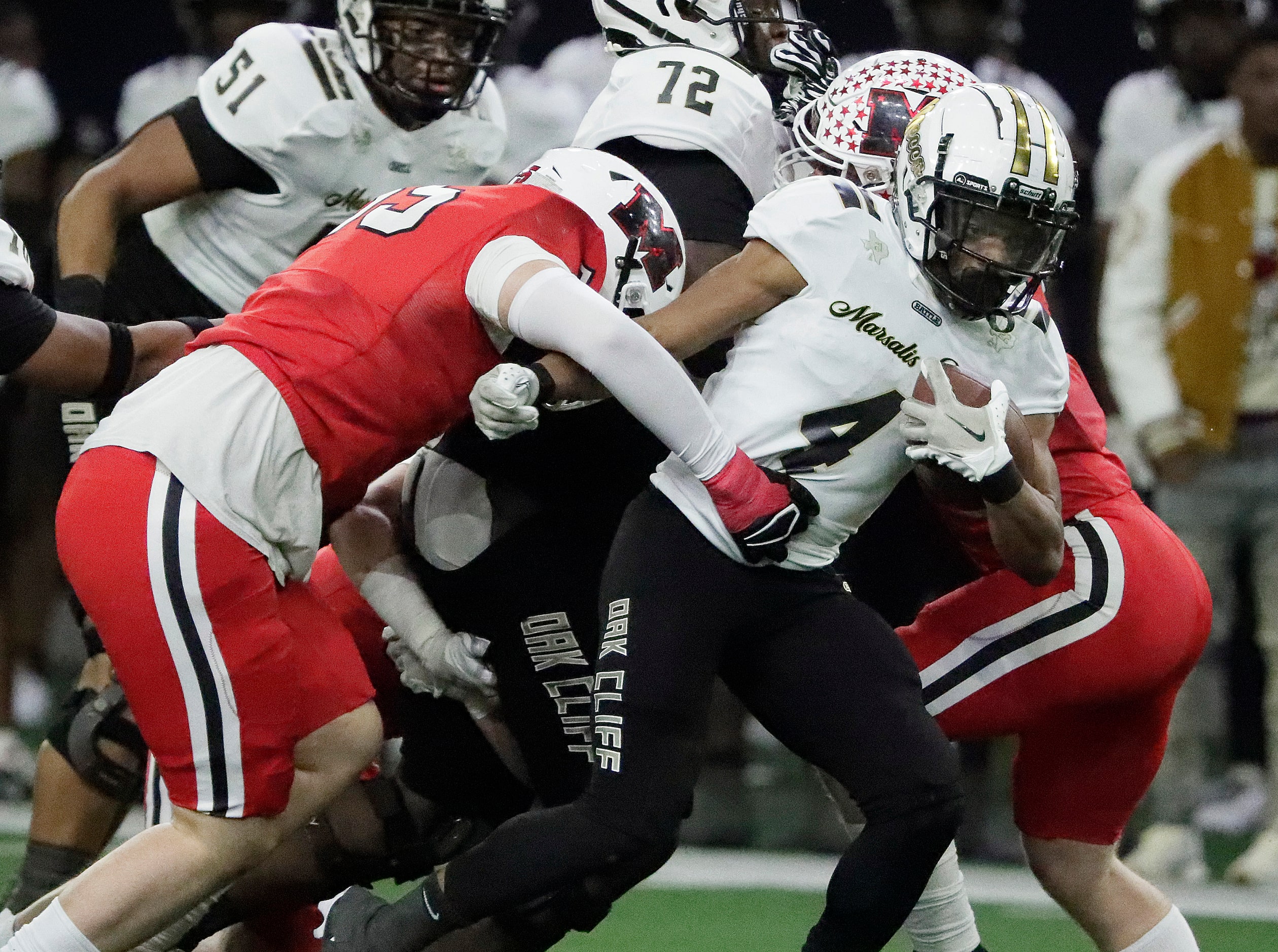 South Oak Cliff High School running back Khalil Ewell (4) slips away from Melissa High...