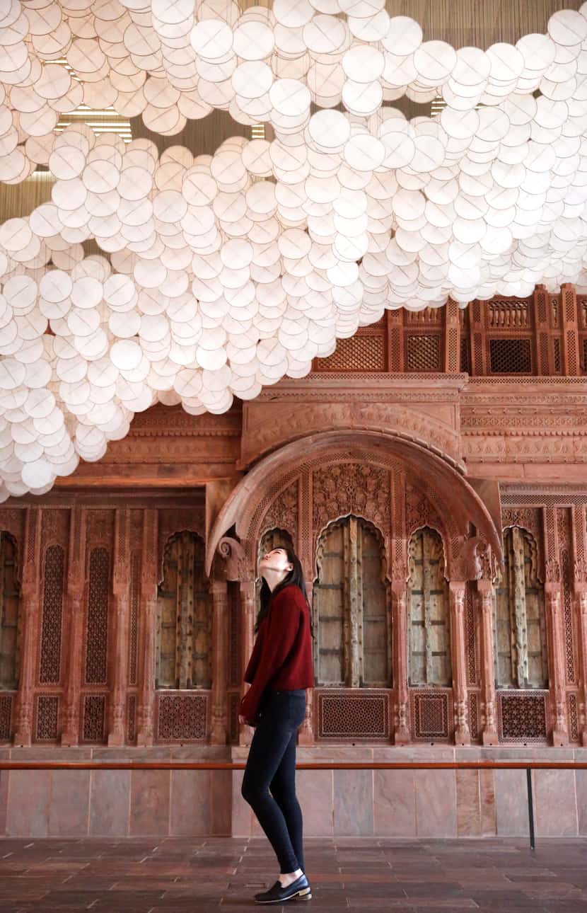 Evelyn Chun looks up at Jacob Hashimoto's installation Nuvole against the Facade of a...
