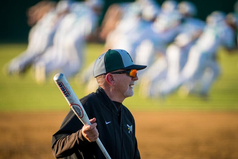 Prosper coach Rick Carpenter hits infield practice before a District 14-5A baseball game...
