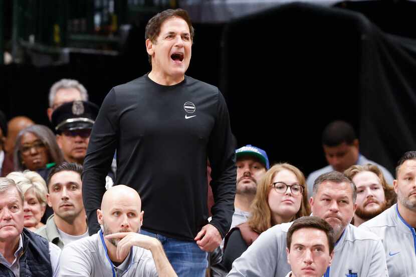 Dallas Mavericks owner Mark Cuban hypes up the team from the sideline during the first half...