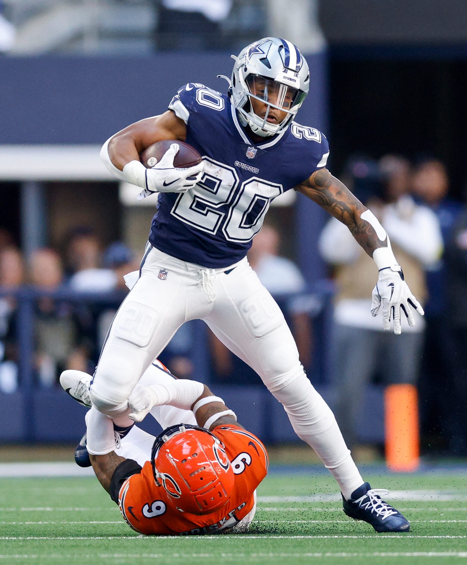 Chicago Bears safety Jaquan Brisker (9) tackles Dallas Cowboys running back Tony Pollard...