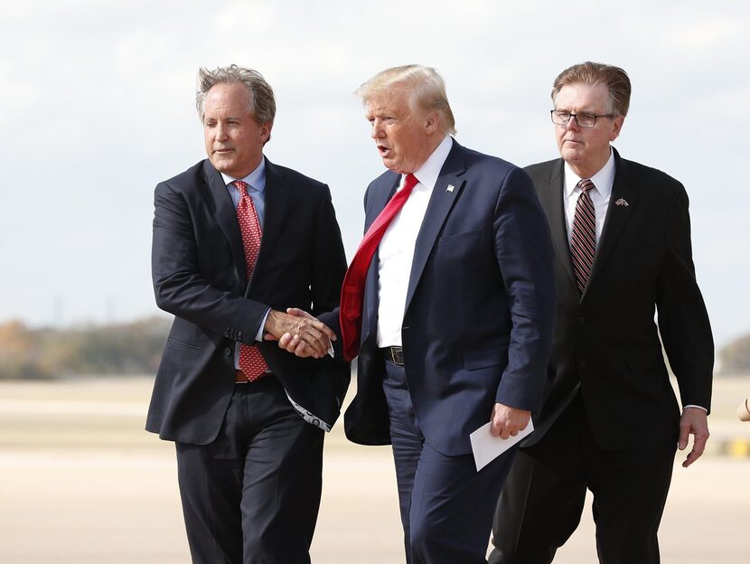 Donald Trump greets Texas Attorney General Ken Paxton as Lt. Governor Dan Patrick follows at...