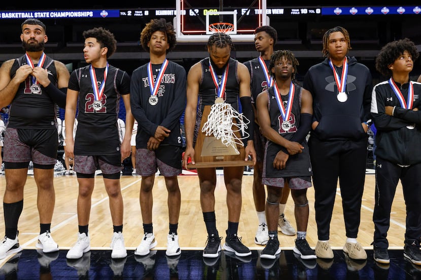 Mansfield Timberview guard Jared Washington (5) holds the state runner-up trophy after the...