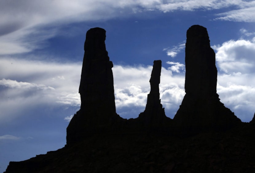 Monument Valley stretches across the Utah-Arizona border characterized by majestic red...