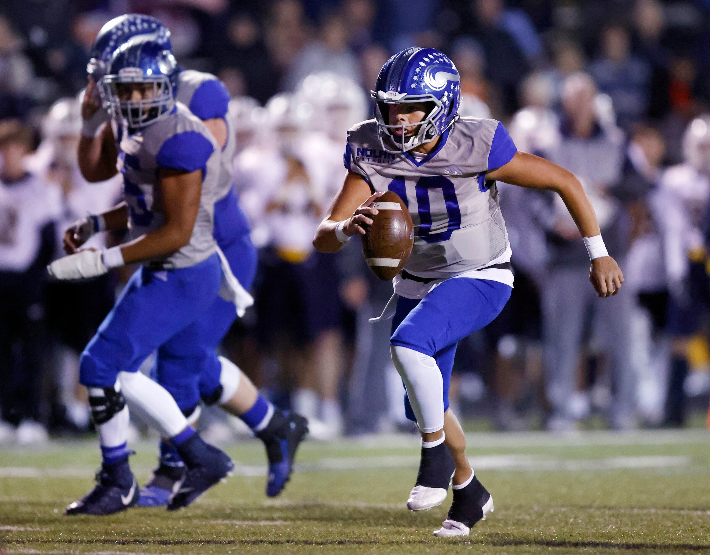 Fort Worth Nolan quarterback Cole Matsuda (10) keeps the ball and runs in a first quarter...