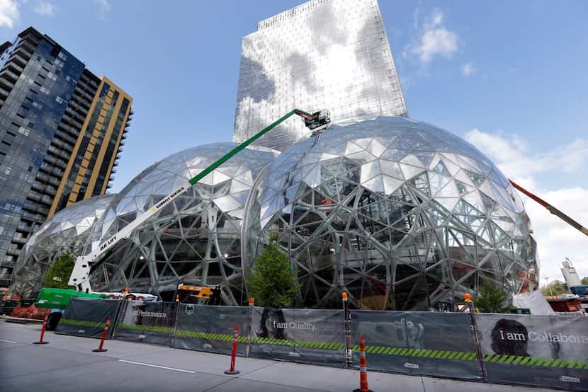 In this April 27, 2017 file photo, construction continues on three large, glass-covered...