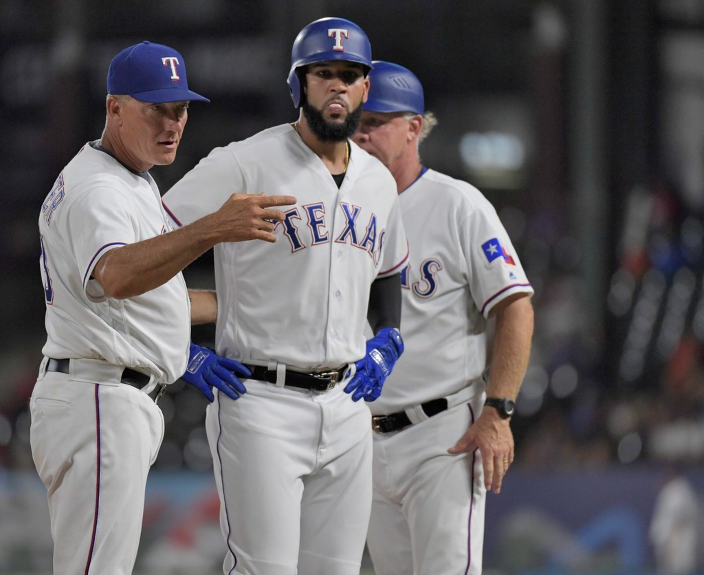 Texas Rangers right fielder Nomar Mazara (30) beats the the throw from third base to first...