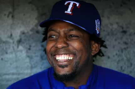 FILE - Vlad Guerrero smiles while sitting in the dugout during a workout session at AT&T...