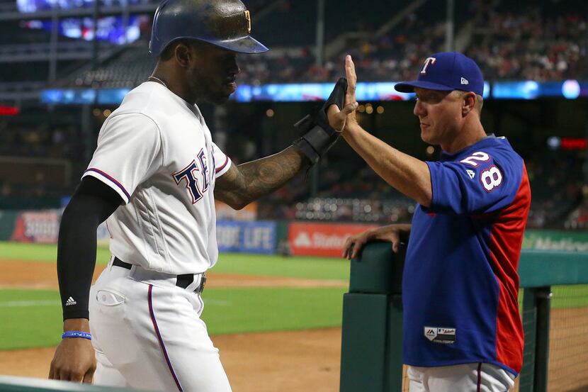 ARLINGTON, TX - SEPTEMBER 26:  Delino DeShields #3 of the Texas Rangers high fives manager...
