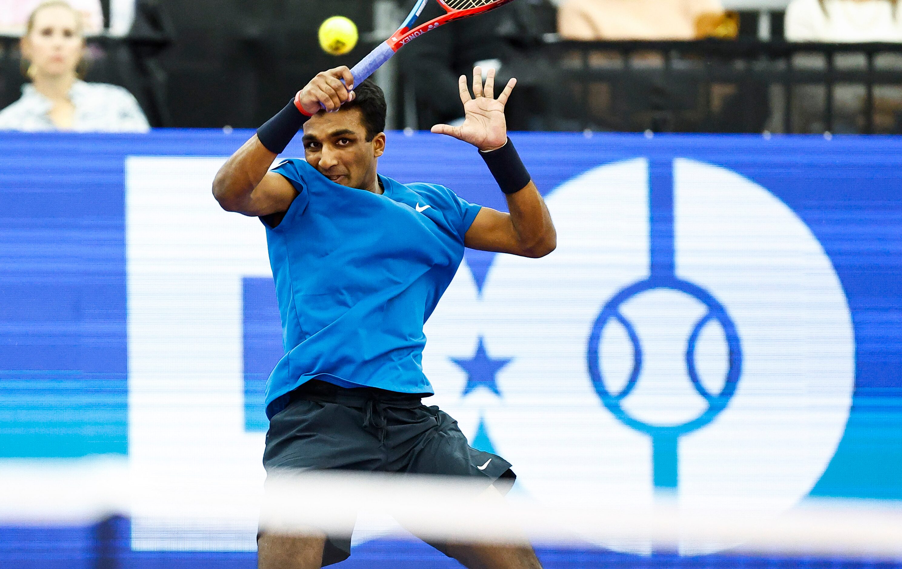 SMU senior Caleb Chakravarthi returns the ball in a match against Vasek Pospisil during the...