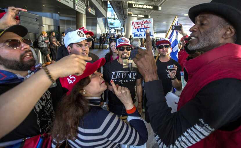 A group of Donald Trump supporters argue with a man (right) who supports a ruling by a...