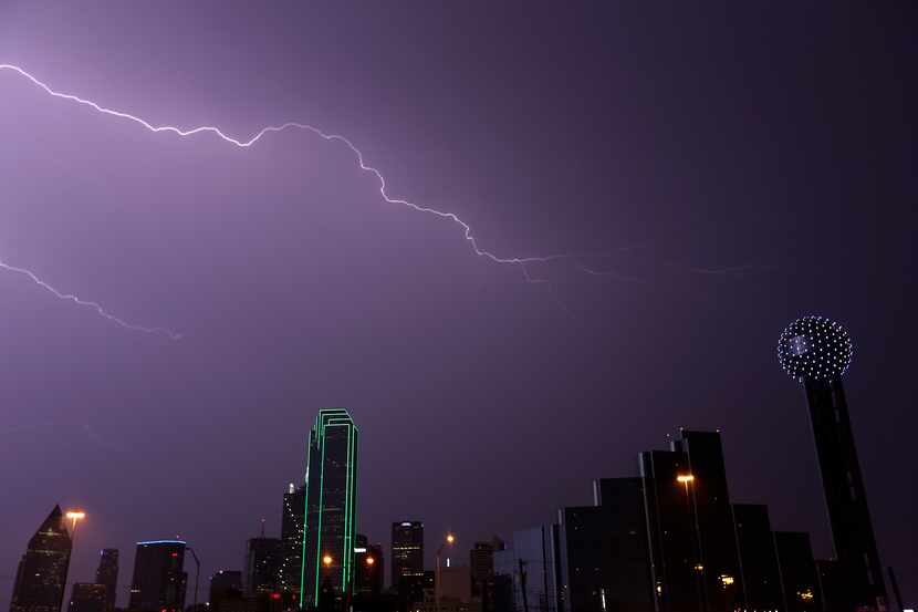 A bolt of lightning strikes over the downtown skyline in Dallas, Tuesday, April 26, 2016....