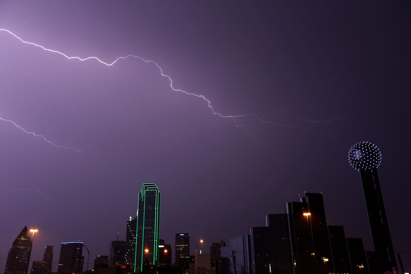 A bolt of lightning strikes over the downtown skyline in Dallas, Tuesday, April 26, 2016....